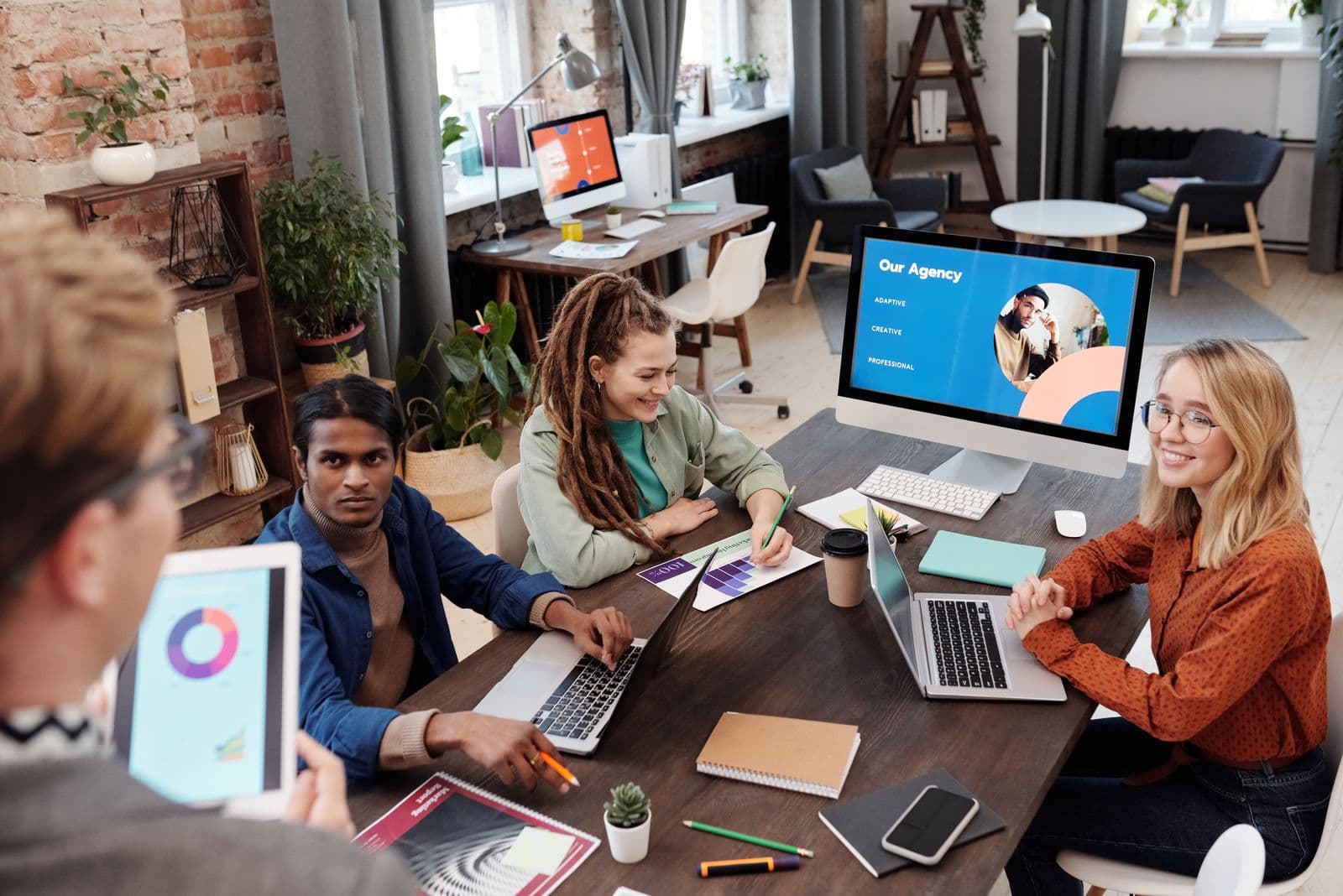 An agency team reviewing work together in a studio